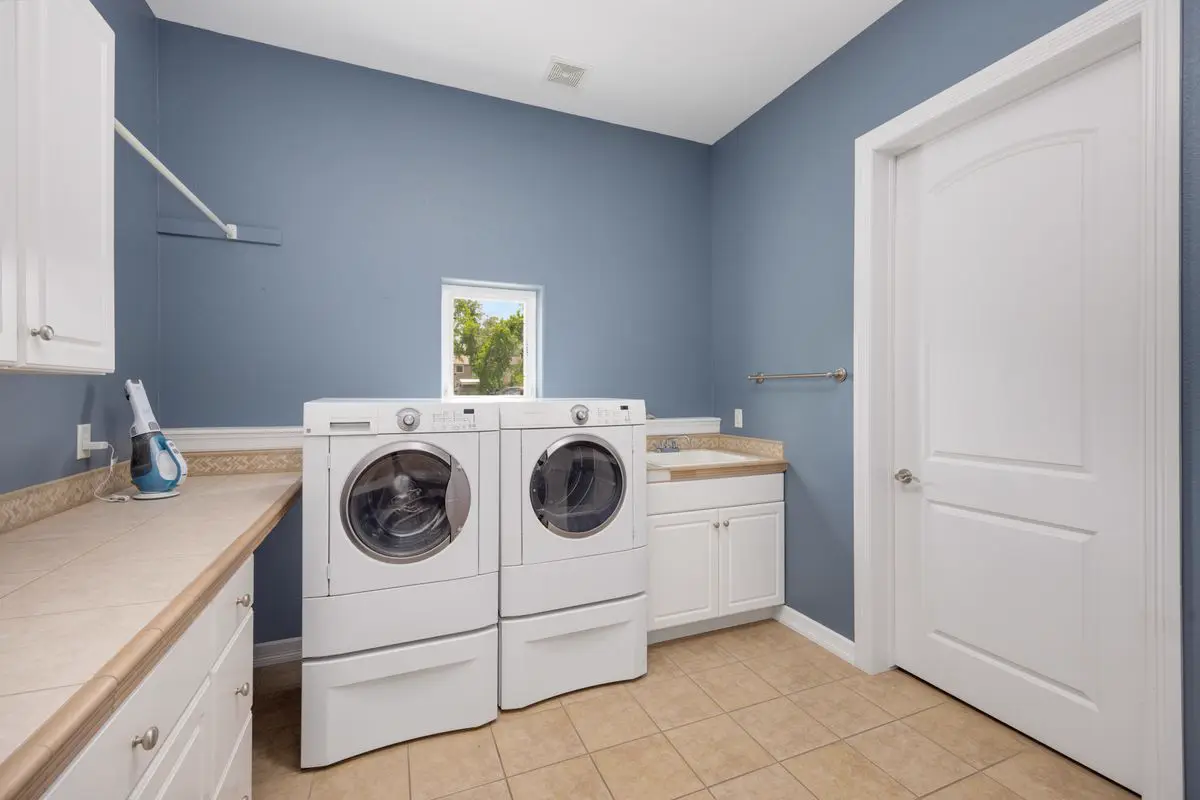 White front-load washer and dryer pair in a home laundry room, a common setup on dryer repair visits in Kingston