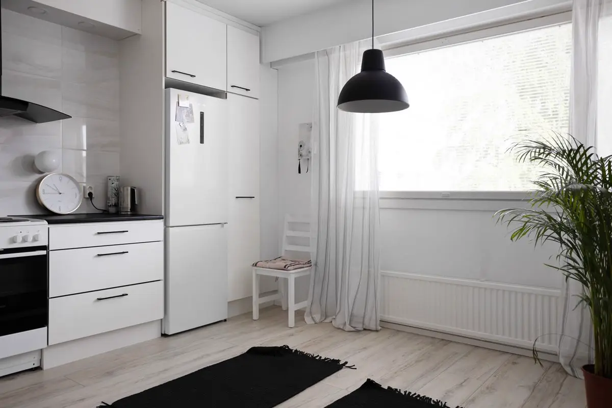 Bright home kitchen with a white refrigerator and electric stove, the kind of setup we see on appliance repair calls across Kingston